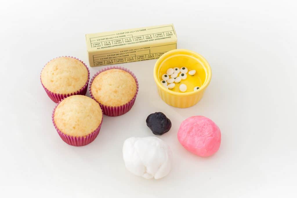 12 of your favorite vanilla cupcakes ½ cup softened butter 2 cups icing sugar 3-4 tbsp milk 8-9 oz. white fondant 12 candy googly eyes 4-6 oz. pink fondant 1-2 oz. black fondant Yields: One dozen cupcakes Begin by checking on your cupcakes: they have to be completely cool before you begin the decorating process. Using an electric mixer, make your butter cream by beating together butter, sugar and milk on medium speed. Gradually increase speed to high. Once the buttercream is formed, scoop it into a piping bag and frost the center of each cupcake (use a round icing tip). Separate your white fondant into 24 spheres, about one inch in size each. Flatten out the white fondant spheres and then point one end. They will act as your bunnies’ ears. Roll out a portion of your pink fondant into 24 small spheres, about 1/3 of an inch in size. Flatten the pink spheres, slightly smaller than your white fondant pieces. Point one end and press one onto each white fondant piece. Insert a toothpick into each fondant bunny ear. With the remainder of your pink fondant, roll out 12 small spheres, about ¼ of an inch thick. Place one on the middle of the frosting of each cupcake. Above it, place 2 of your googly candy eyes. Roll out small, thin strips of your black fondant – you’ll need 48 of them. Place the black strips on your bunnies’ faces – 2 on either side of its nose. Gently insert 2 fondant bunny ears on the top of each cupcake. Serve, enjoy and Happy Easter! 