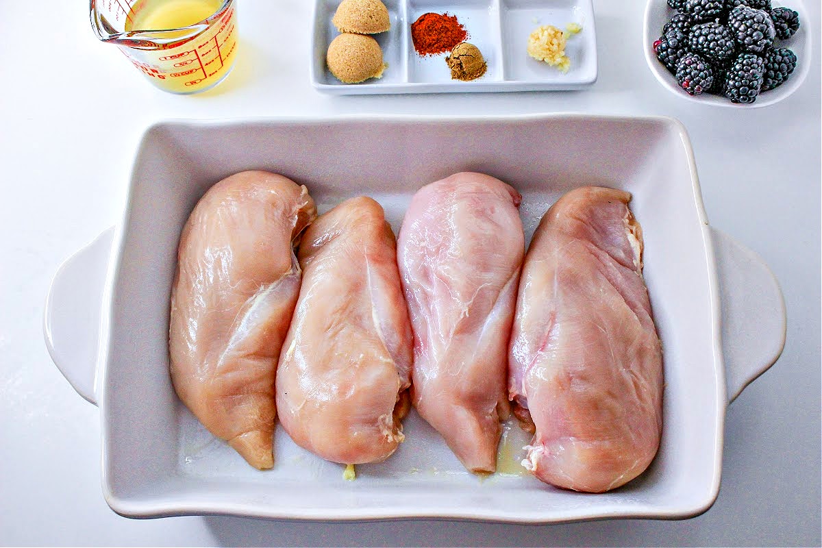 4 skinless, boneless chicken breasts in a white casserole dish