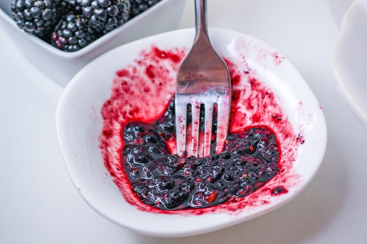 Smashing Blackberries in a small bowl