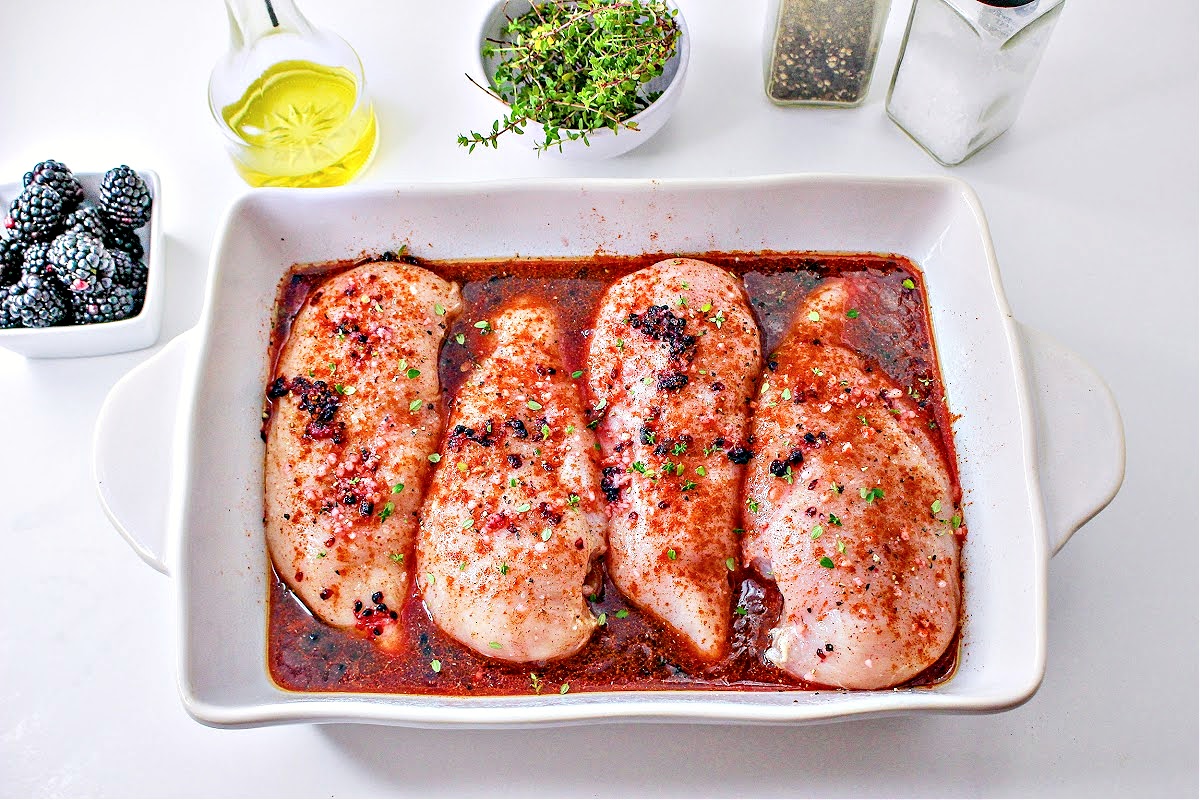 Seasoned chicken breasts in a casserole dish and ready for the oven