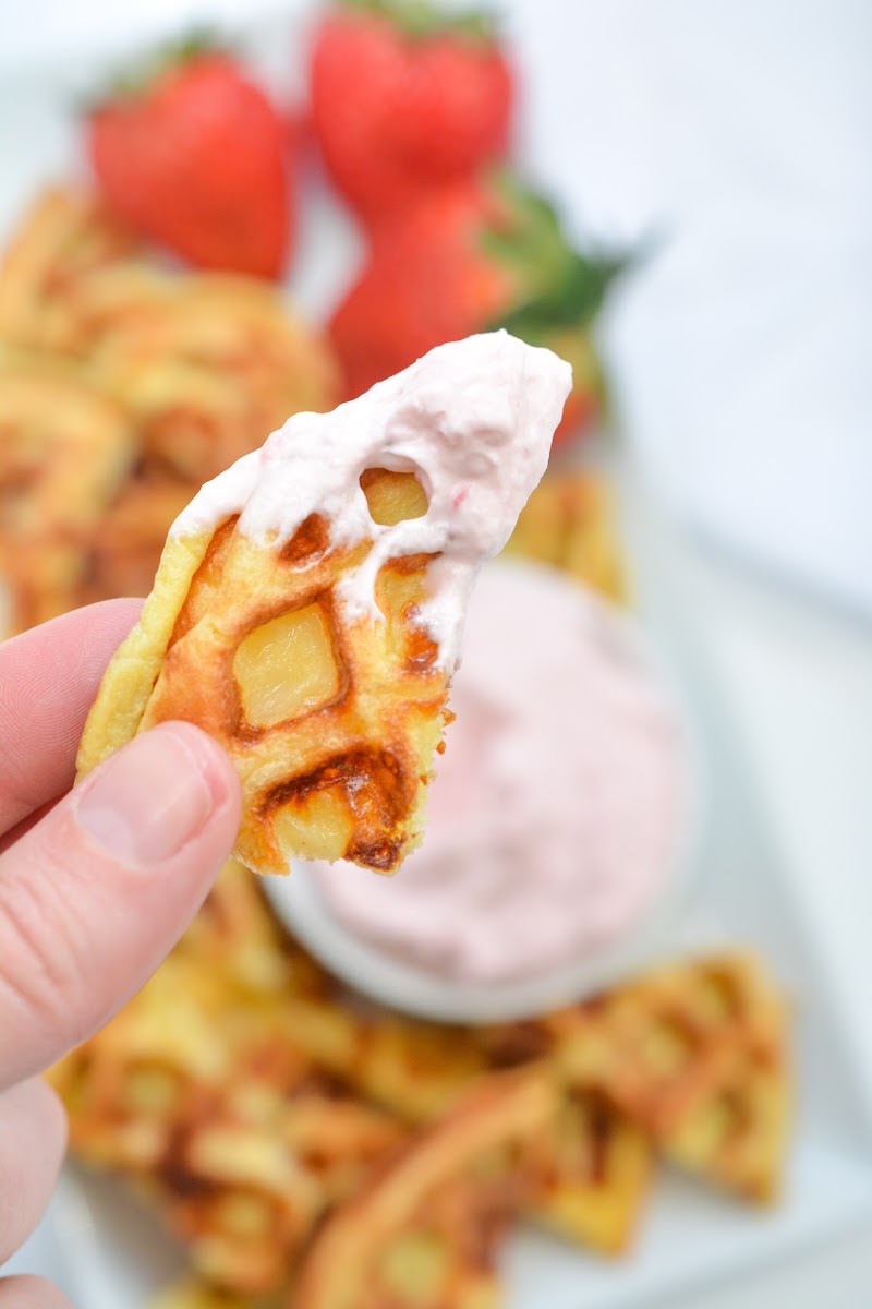A chaffle chip with strawberry dip on it