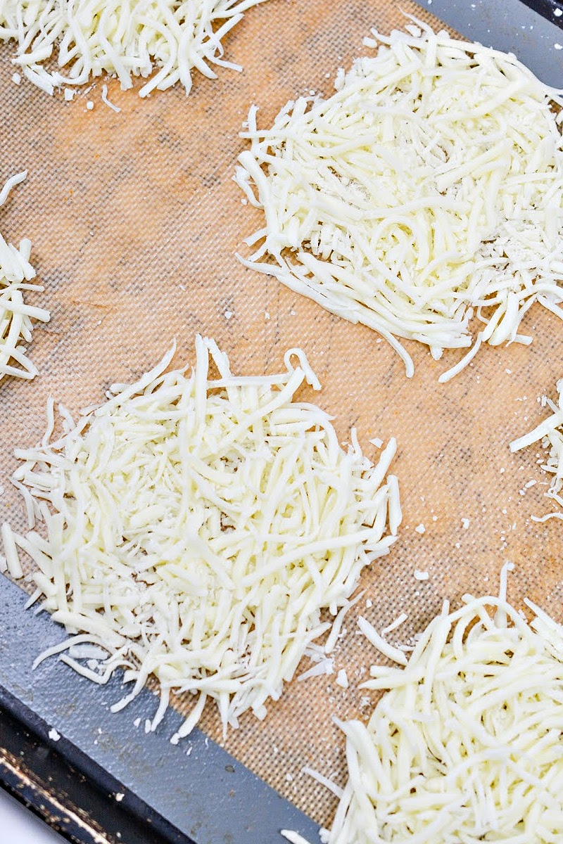 Shredded mozzarella on a baking sheet to make wraps