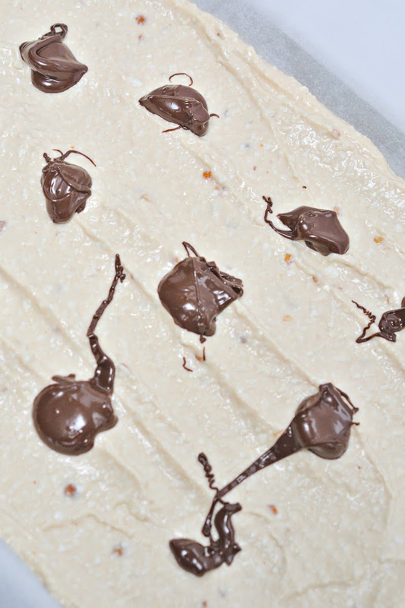 Dollops of melted chocolate on top of Keto Frozen Cottage Cheese Bark batter