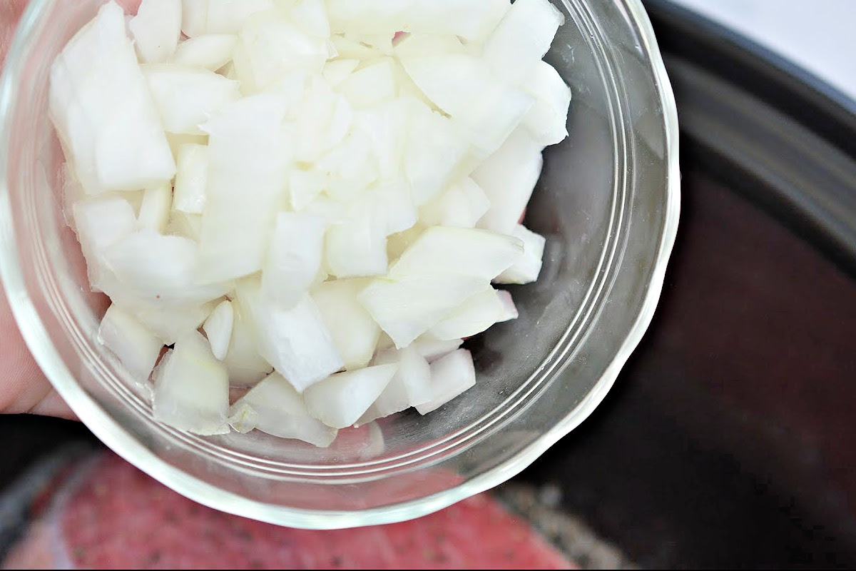 Adding diced onions to the slow cooker