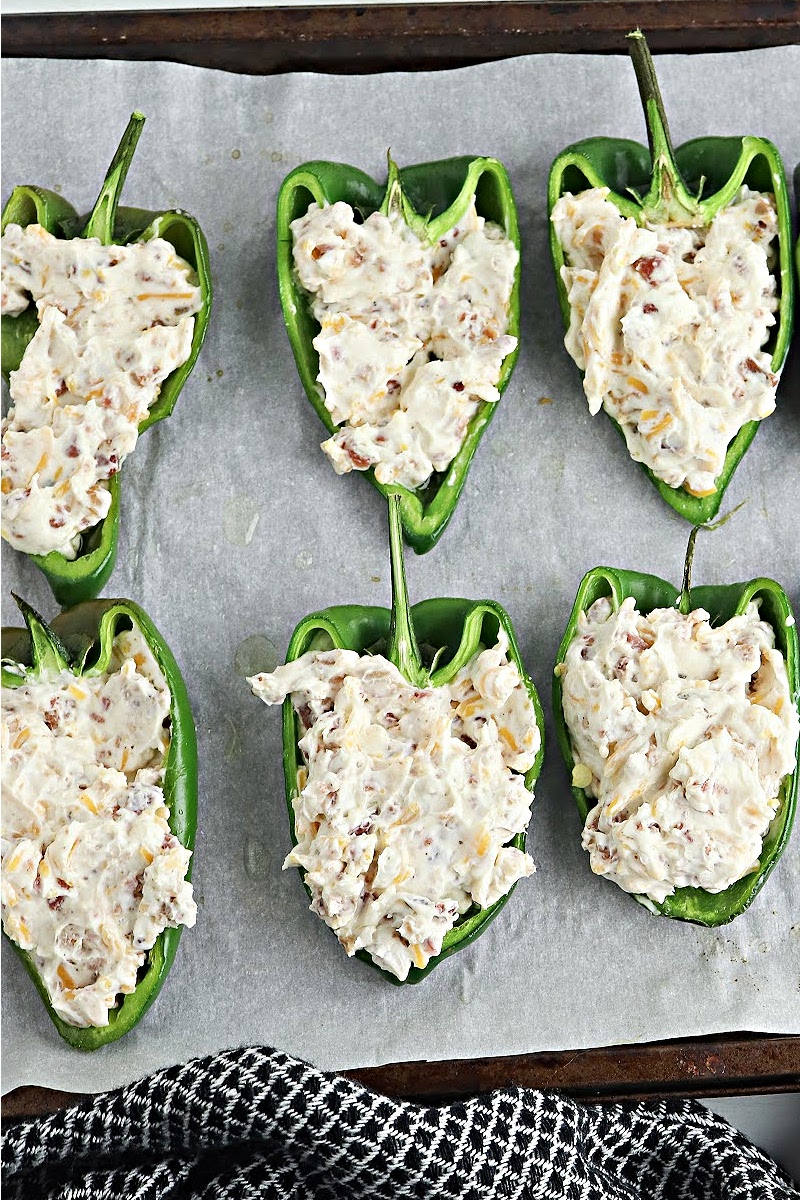 Adding cream cheese mixture to hollow poblano pepper halves