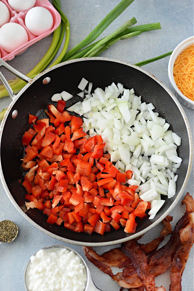Chopped bell pepper and onion in a skillet