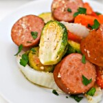 A white plate of Low Carb Honey Garlic Sausage and Veggies.