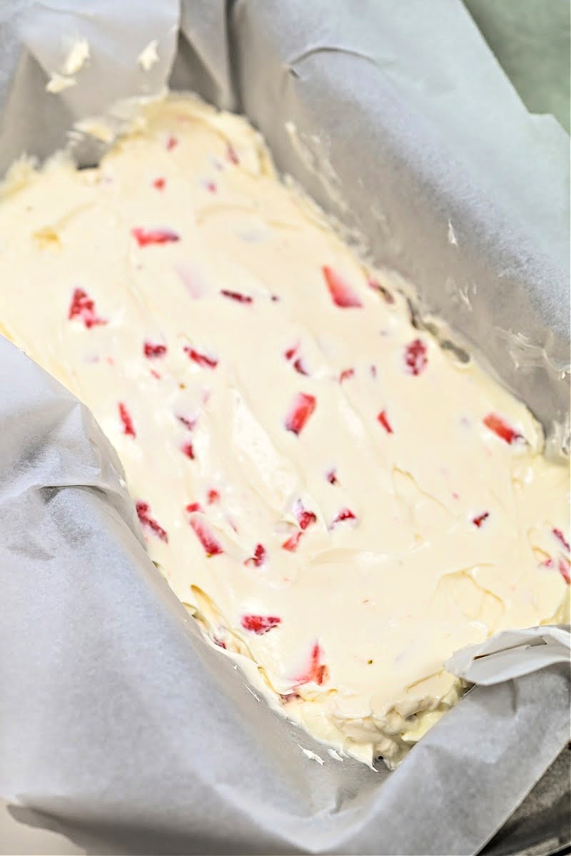 Keto Strawberry Cream Fudge in a parchment-lined loaf pan