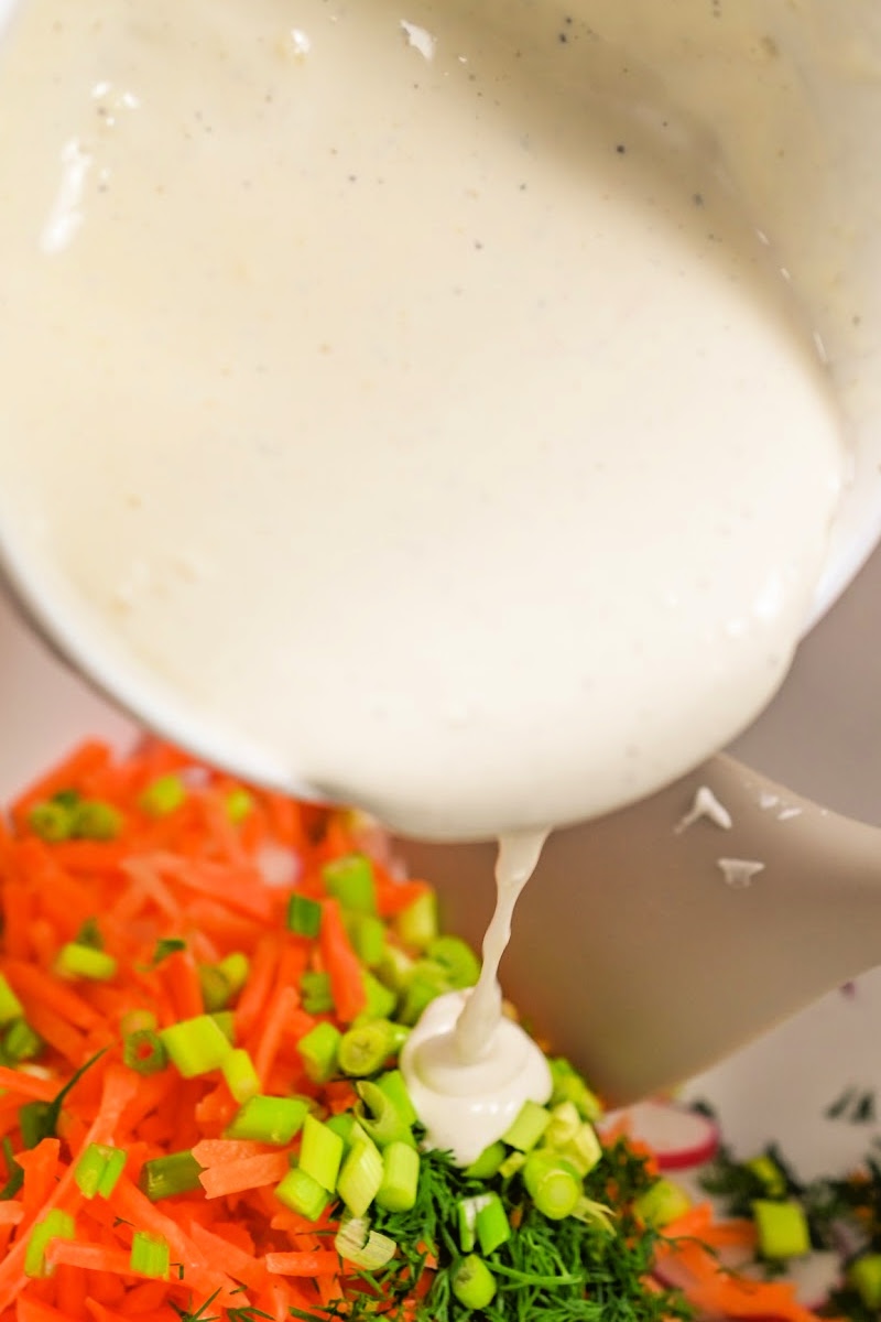 Adding dressing to the salad