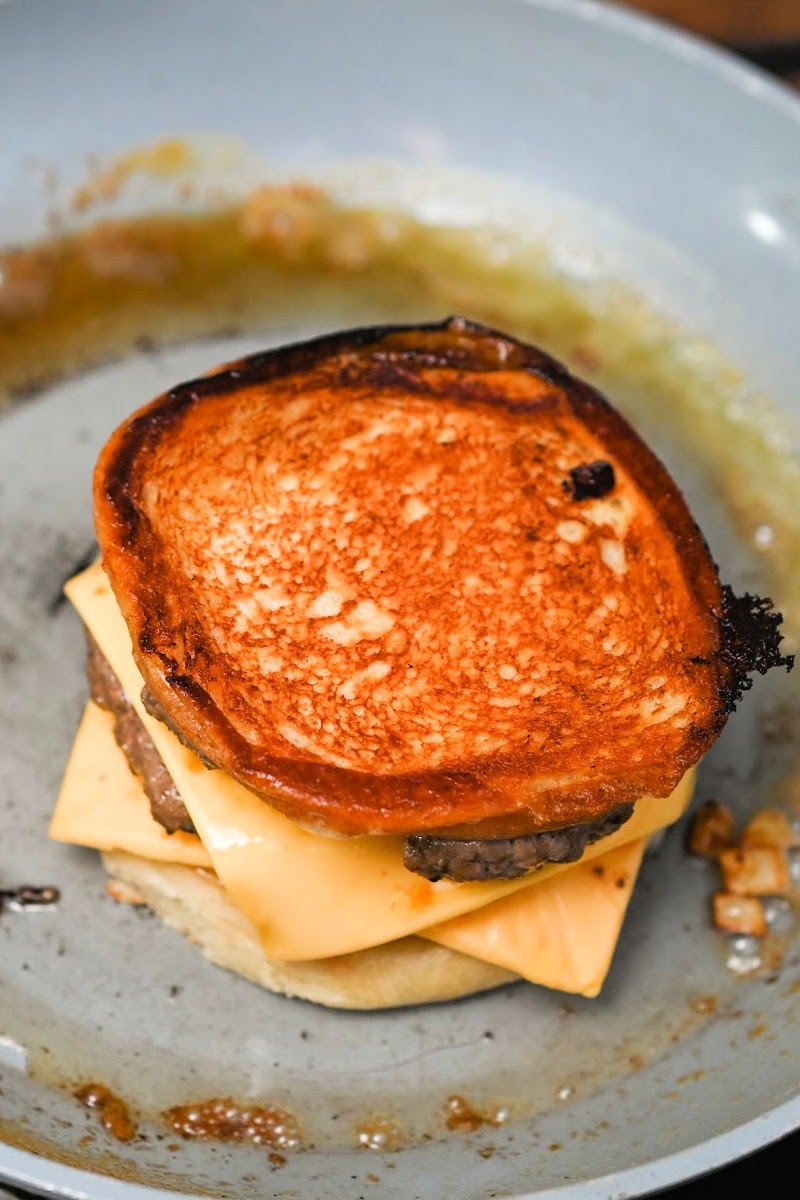 Grilling the grilled cheese cheeseburger in a skillet