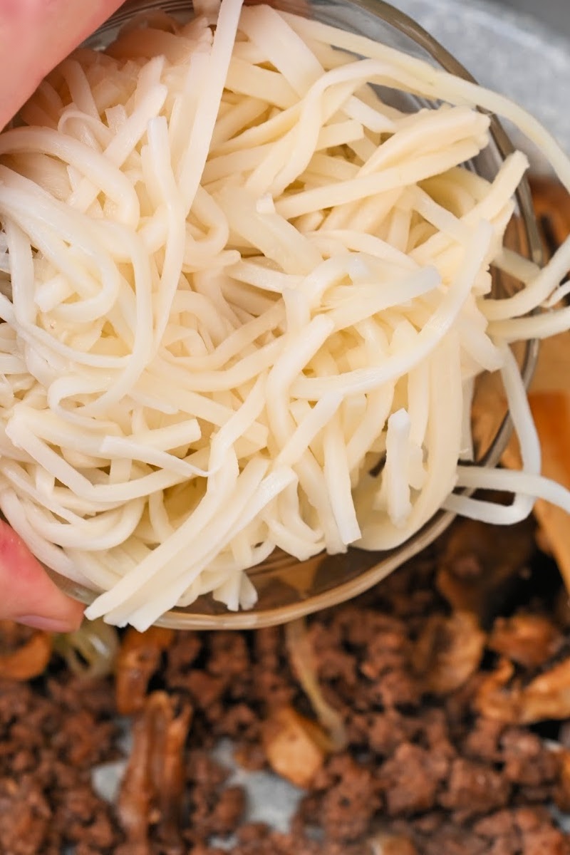 Adding the pasta to the skillet