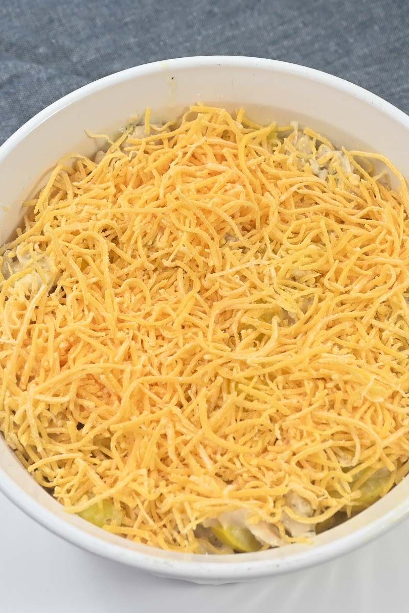 Adding cheddar cheese to the casserole