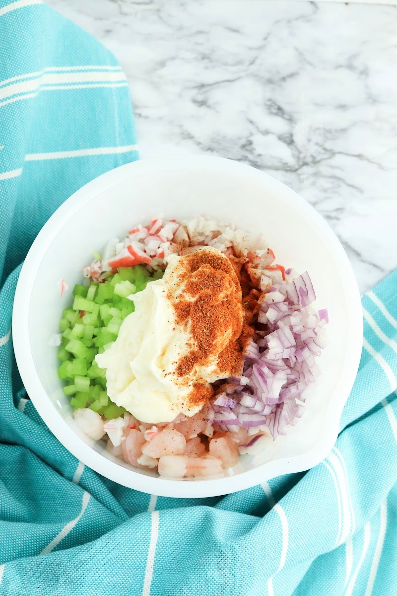 Adding dressing to the salad