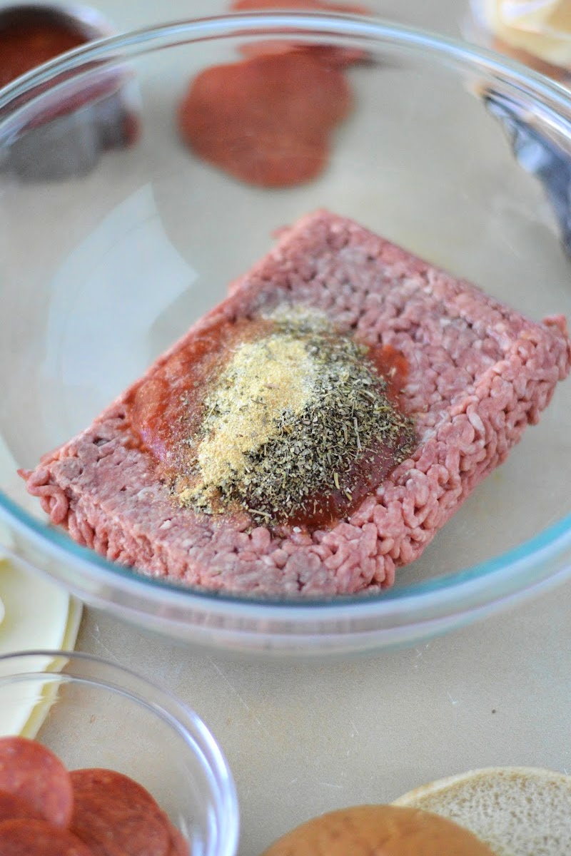 Adding spices to the hamburger patties