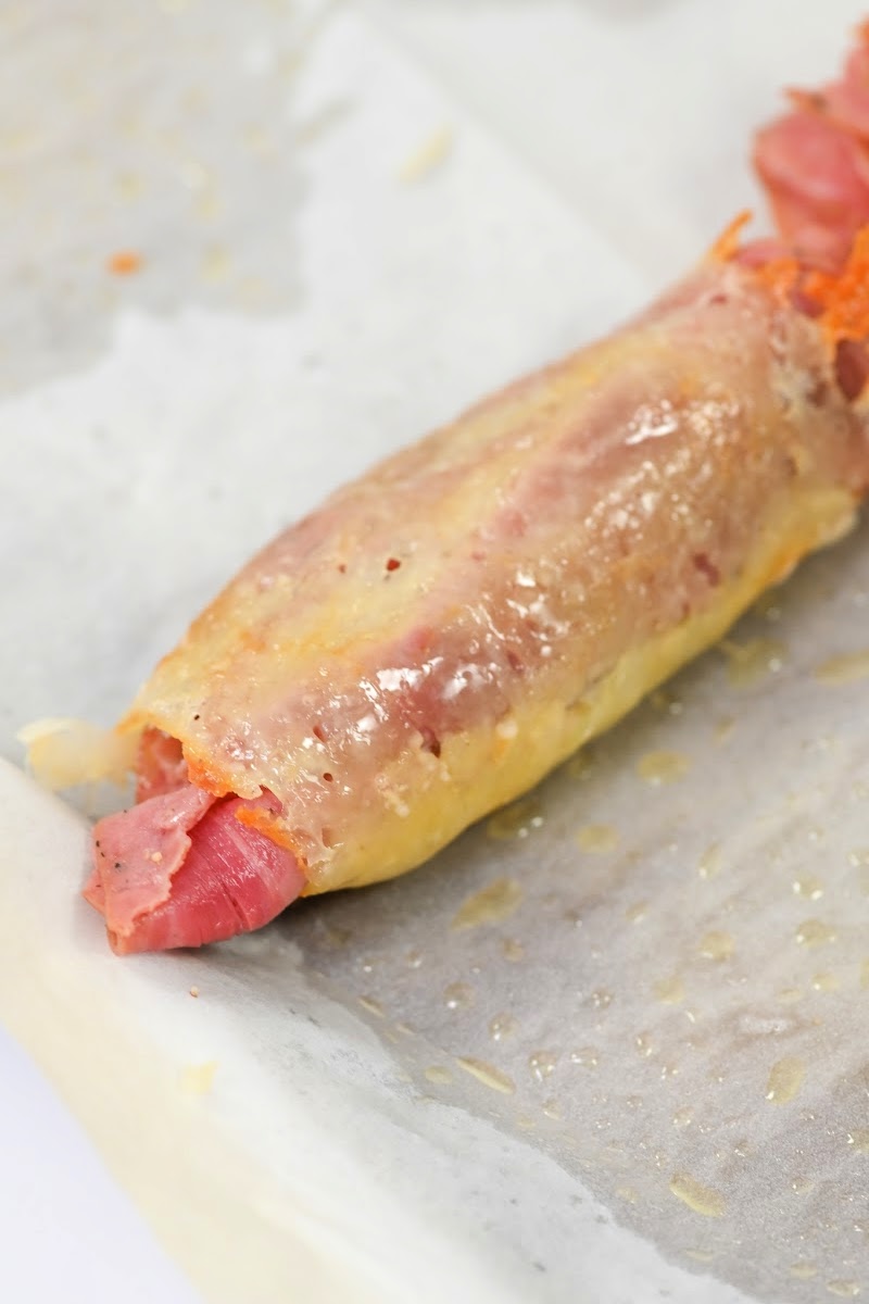 Rolling the cheese wrap around the Reuben ingredients