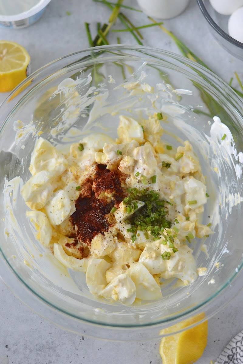 Adding spices to the egg salad