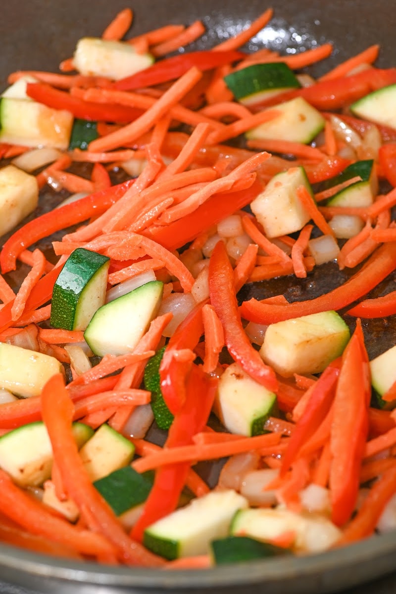 Cooking zucchini with the carrots and peppers