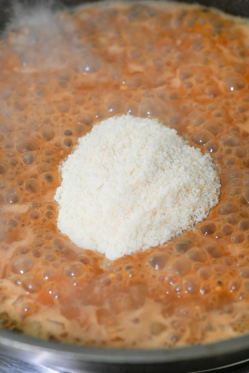 Adding the cheese to the sauce