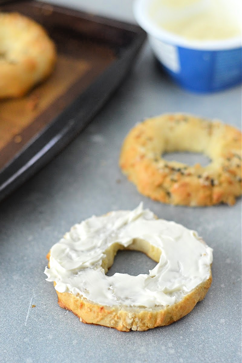 Spreading cottage cheese on Keto Cottage Cheese Bagels