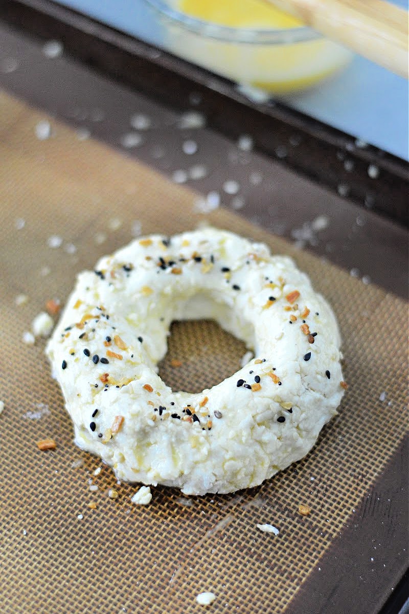 Unbaked keto bagels on a baking sheet