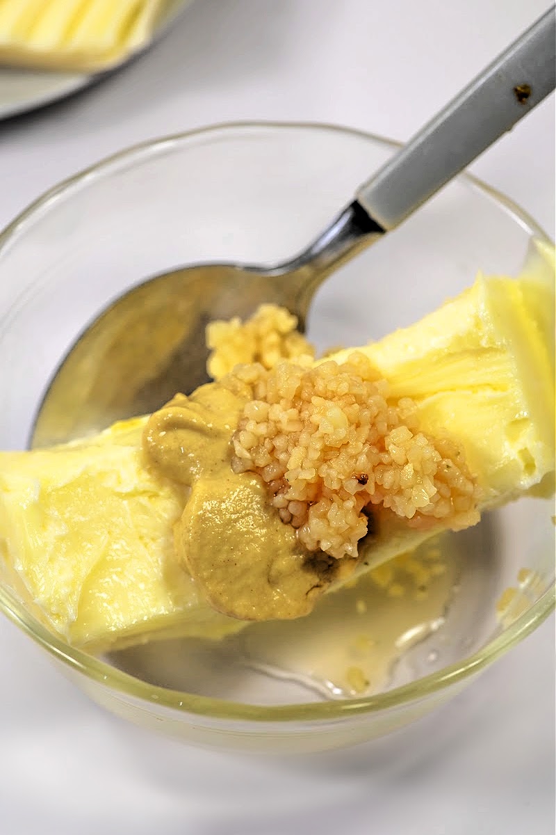 mixing butter, garlic, and mustard