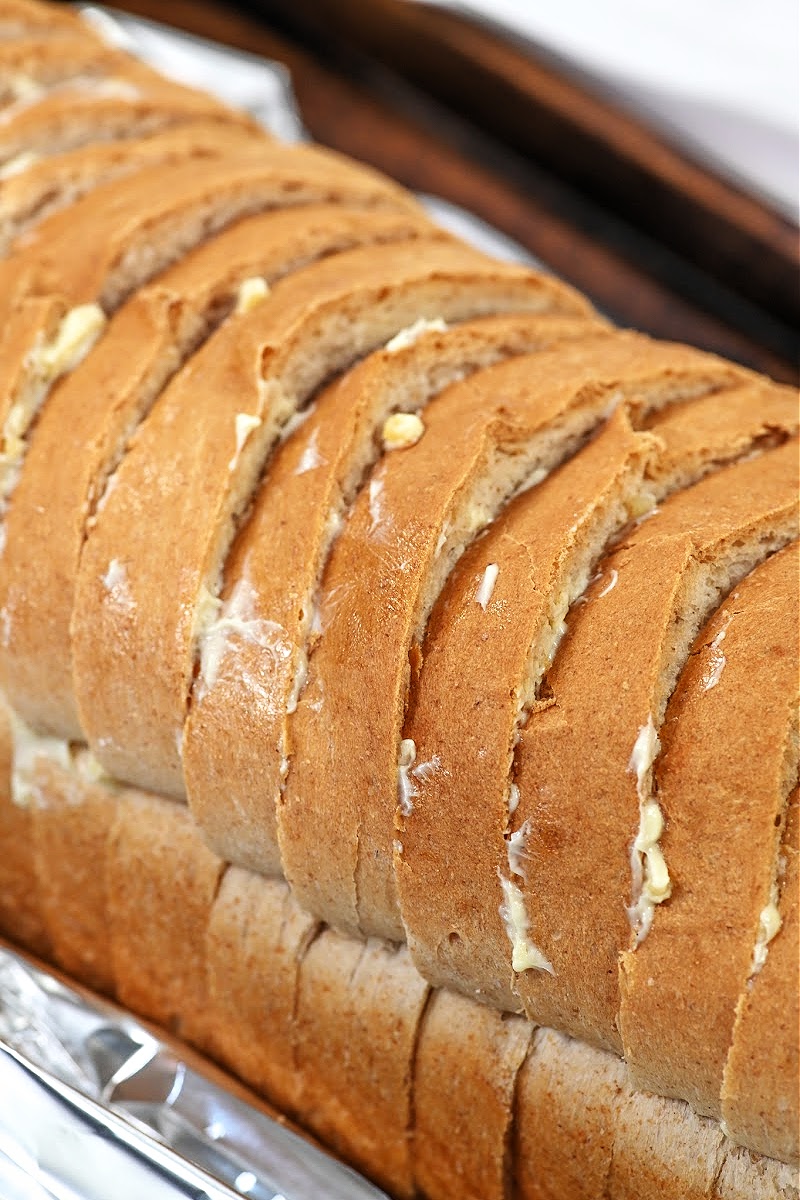 Spreading butter on each piece of bread