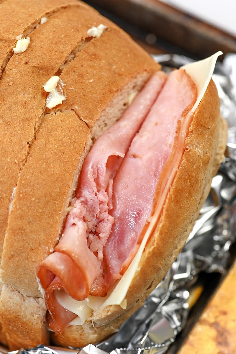 Adding ham to the loaf of bread