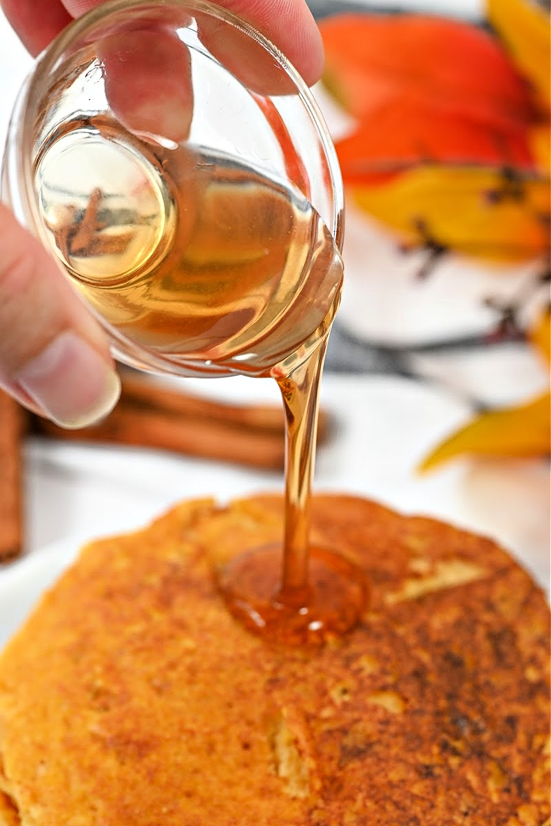 Adding sugar-free maple syrup on top of pancakes