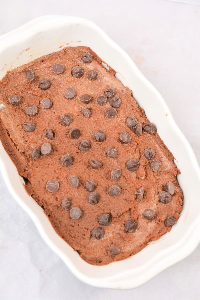Adding chocolate chips on top of the bread