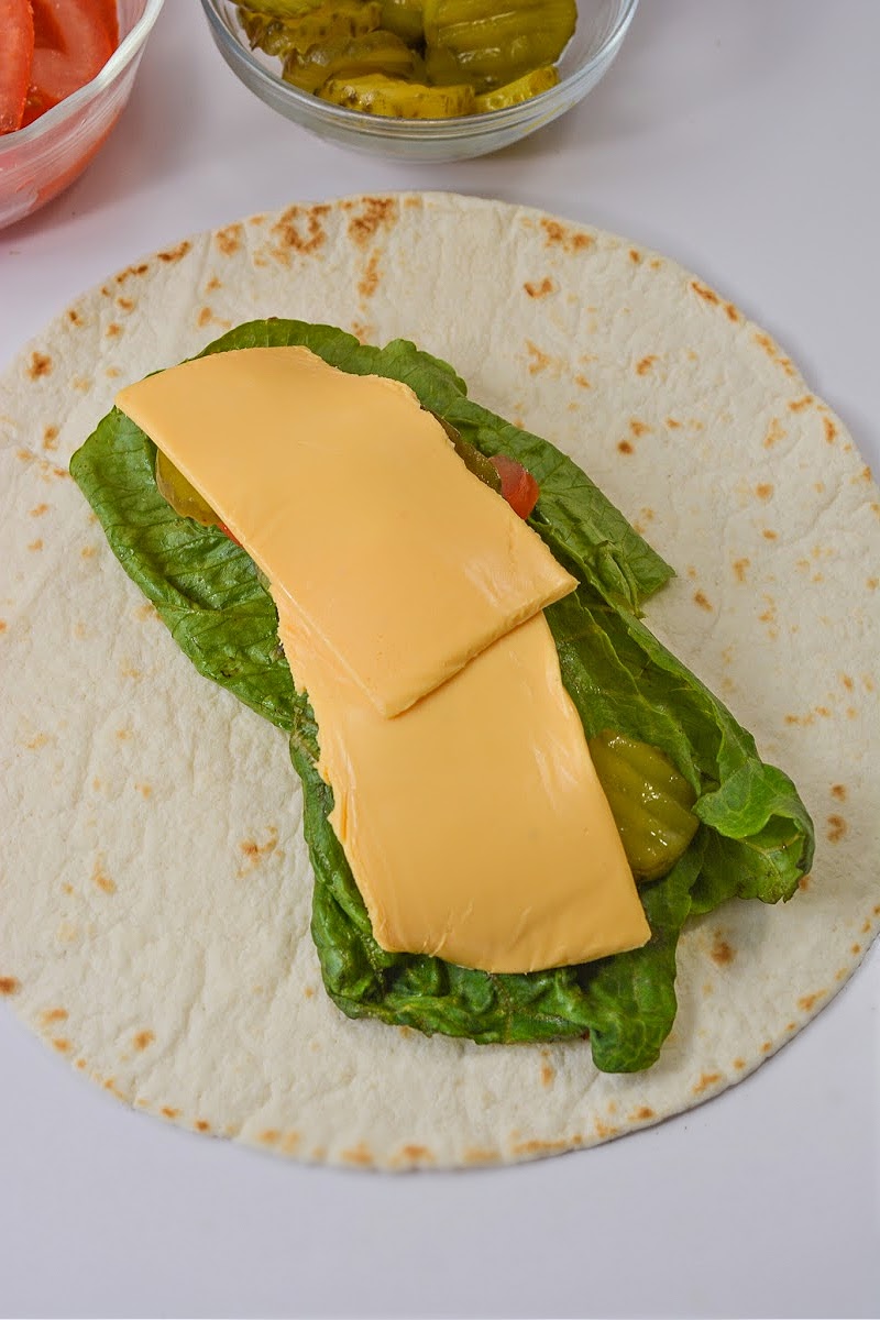 Adding American cheese on top of pickles