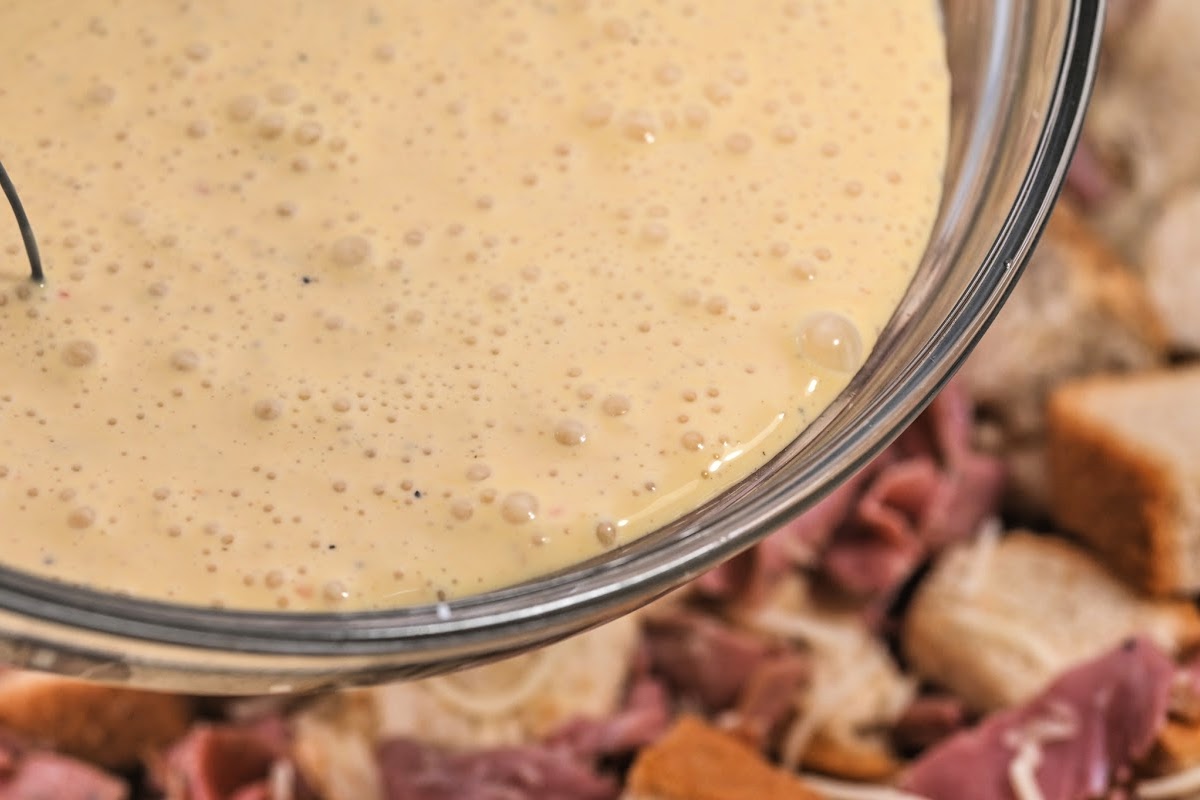 Adding the dressing to the bread pudding ingredients