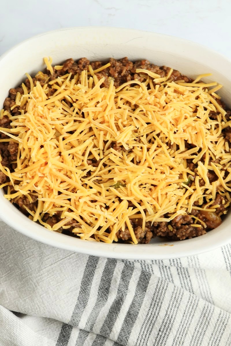 Adding shredded cheese on top