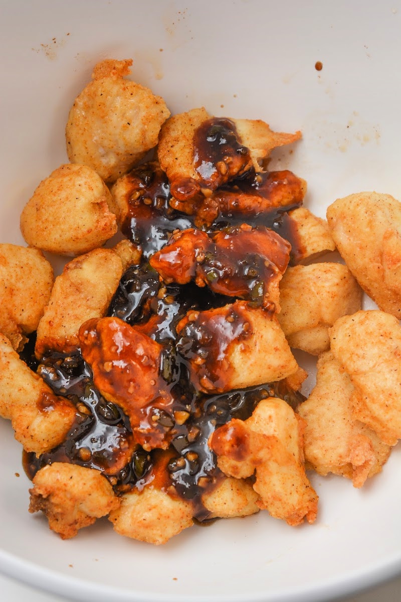 Adding sauce to the cooked chicken