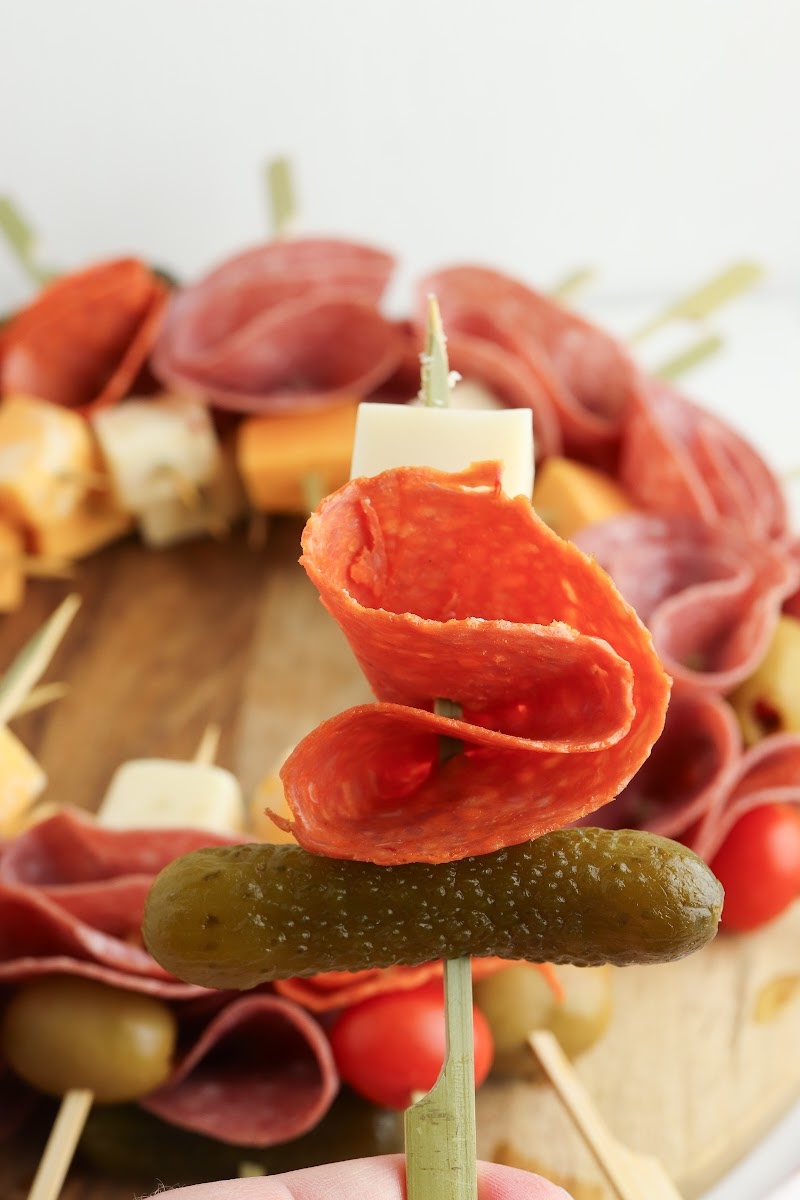 Adding cheese and meat to a toothpick