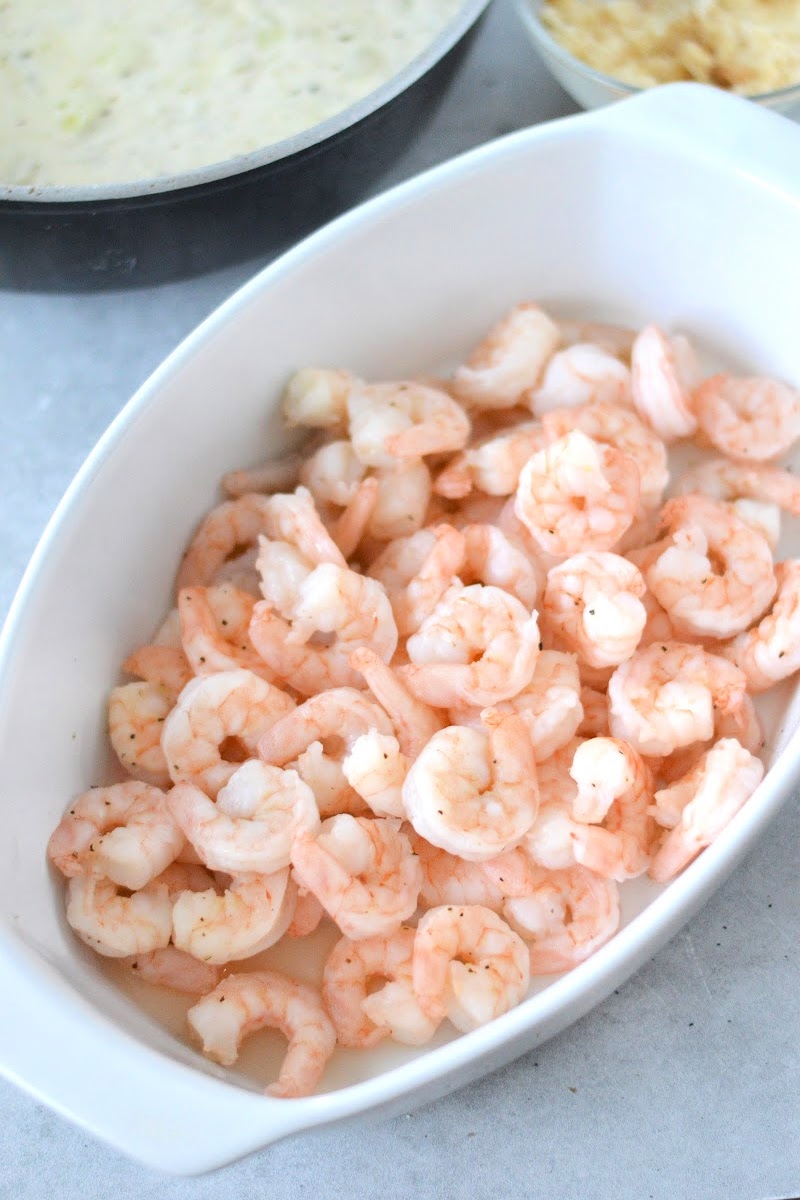 Placing cooked shrimp into the casserole dish