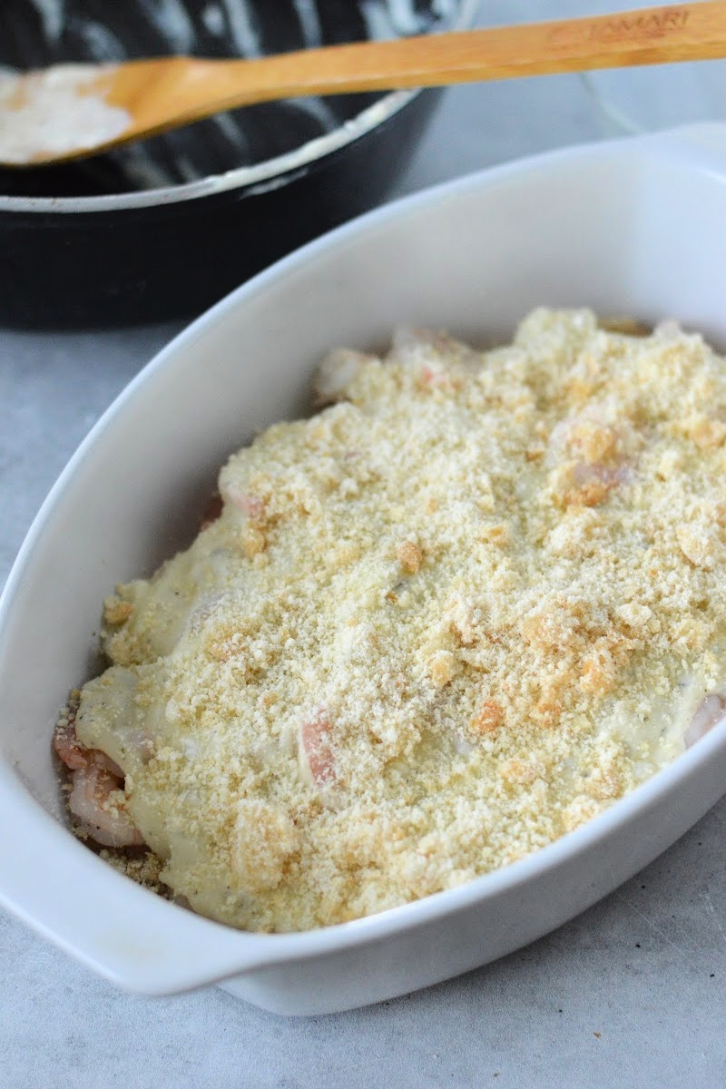 Adding the crumb topping to the au gratin casserole