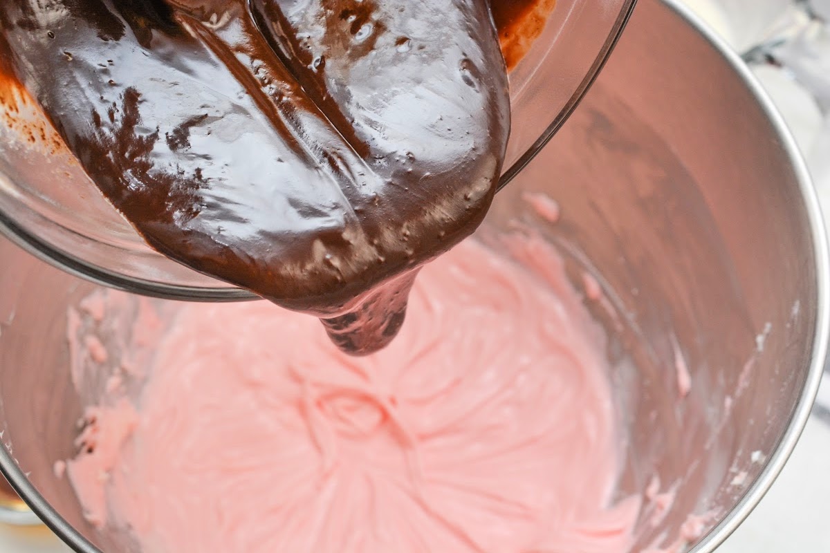 Adding chocolate to the cream cheese mixture