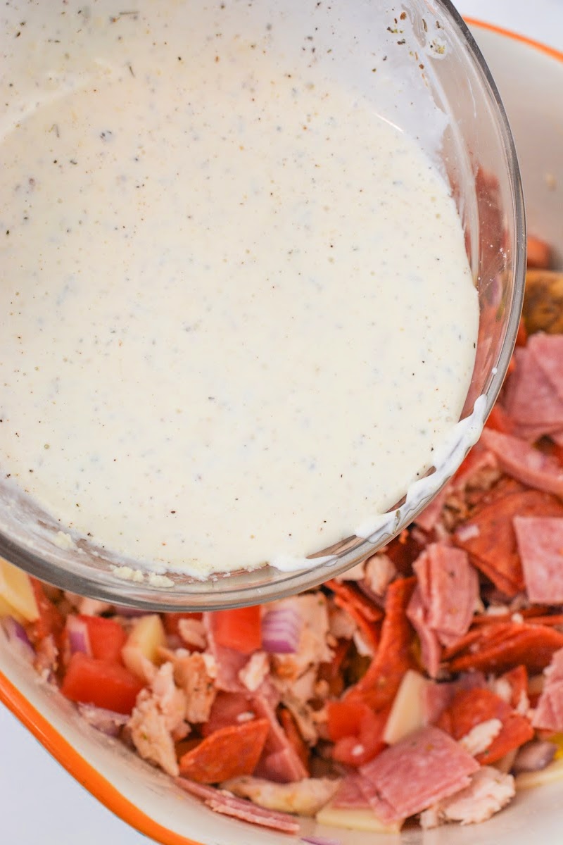 Adding salad dressing to the salad