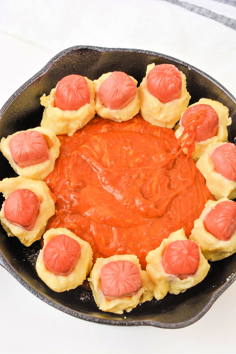 Adding chili sauce to the middle of the skillet