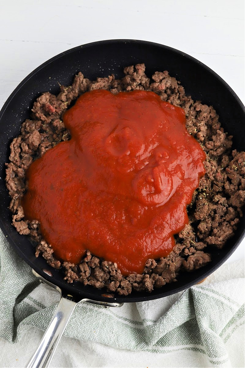 Adding sauce to the ground beef