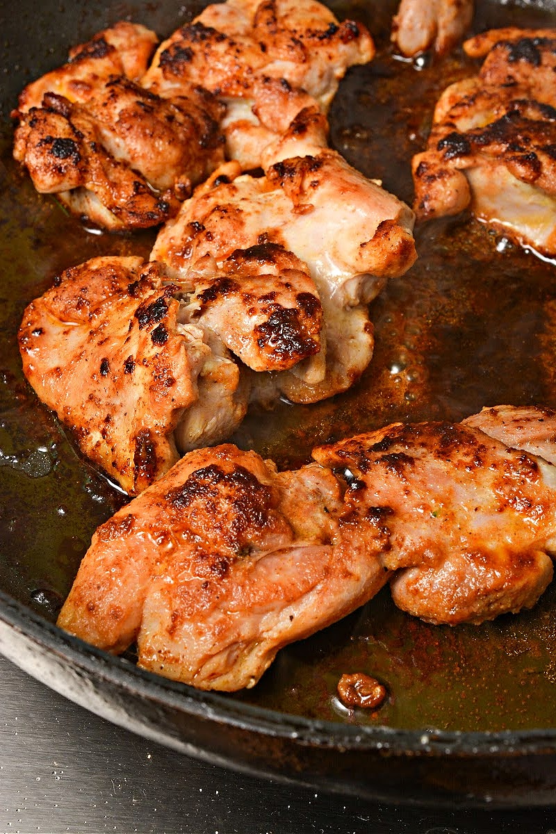 Cooking chicken thighs in a skillet