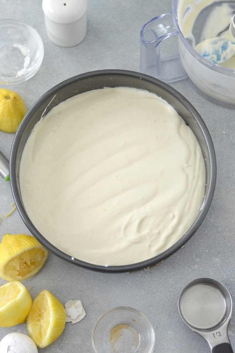 Adding cheesecake filling to the pan