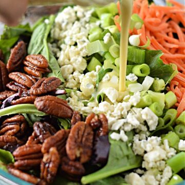 Adding dressing to the salad