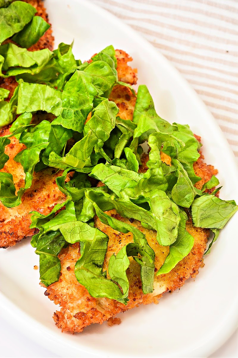Adding the lettuce on top of the chicken